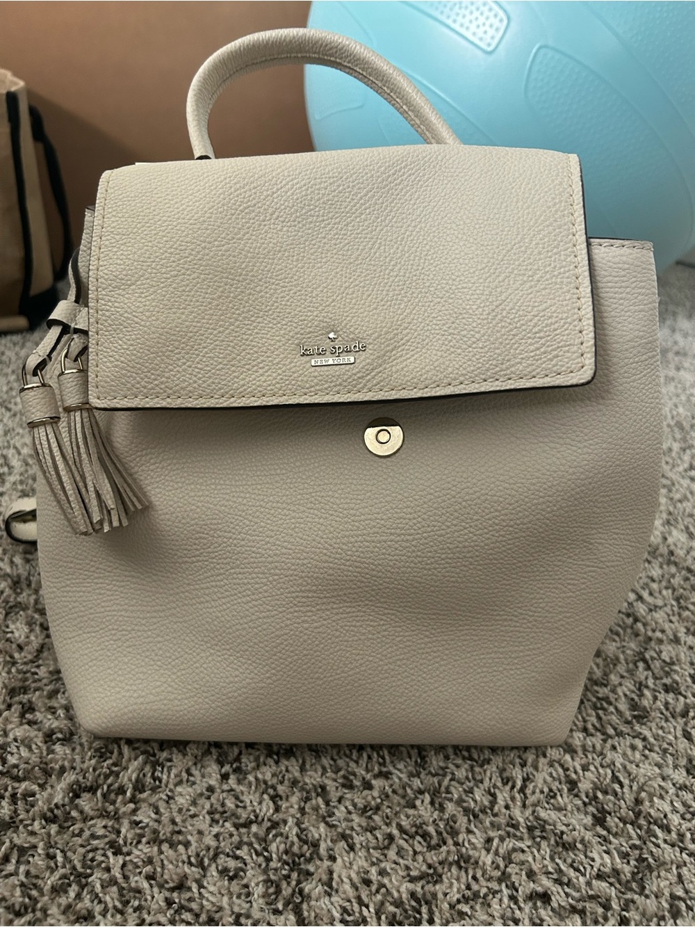 kate spade cream pebbled leather backpack with tassel
